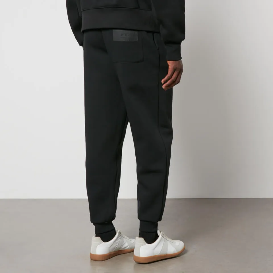 AMI Tonal Logo Cotton-Jersey Joggers - S | Coggles